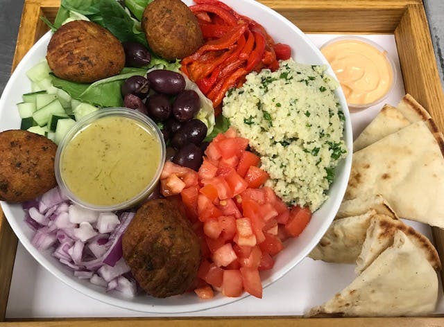 a bowl filled with different types of food on a plate